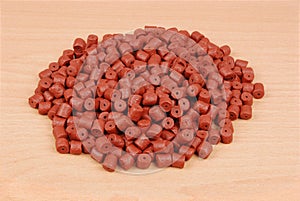 Red pre-drilled halibut pellets