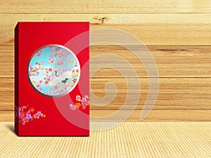 Red premium Chinese gift box for Chinese New Year, Anniversary, Mid-Autumn Festival, Valentine`s Day, Birthday. On wooden