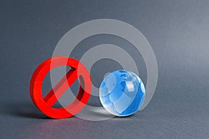 Red prohibition symbol NO and planet earth glass ball. Prohibitions, obstacles and censorship, opponents of globalization