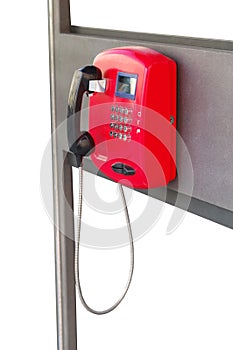 Red public telephone on a white