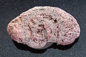 red pumice stone on dark background