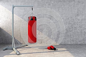 Red punching bag with a concrete wall