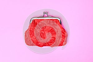 Red purse on a pink background. Red wallet for coins