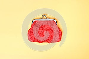 Red purse on a yellow background. Red wallet for coins