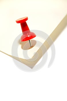 Red pushpin and note paper