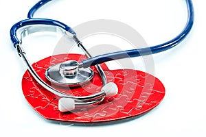 Red puzzle heart with stethoscope isolated on white background