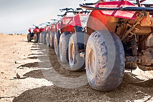 Red quads stand in a row on the shore of the Red Sea. Dahab, Egypt.