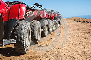 Red quads stand in a row on the shore of the Red Sea. Dahab, Egypt.