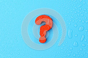 Red question mark on a blue background with water drops. Choice, faq concept