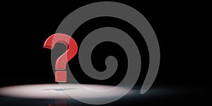 Red question mark Spotlighted on Black Background photo