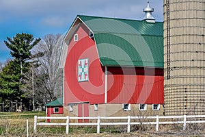 Red Quilt Barn with White Fence and Silo
