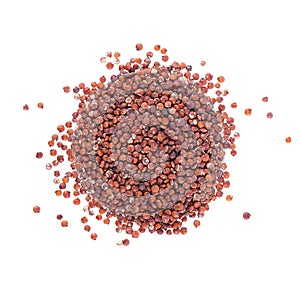 Red quinoa seeds isolated on white background. Pile of raw kinwa. Top view.