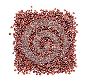 Red quinoa seeds isolated on white background. Pile of raw kinwa. Top view.