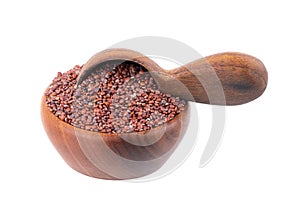 Red quinoa seeds in wooden bowl and spoon, isolated on white background. Pile of raw kinwa.