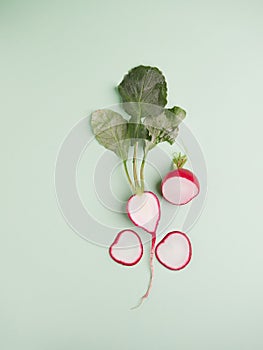 red radish with leaves cut in half lengthwise with leaves