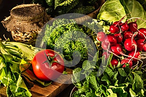 Red radish, tomato, cabbage, lettuce and lemon balm on the table. Vegetarian foods