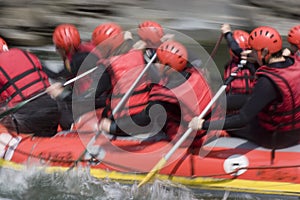 Red rafting team on whitewater