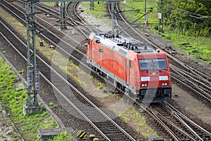 Red railway train making maneuvers