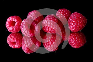 Red raspberries on a black background