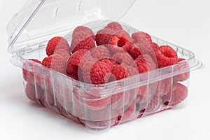 Red raspberries in plastic container