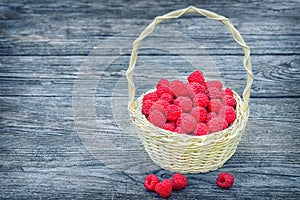 Red raspberries. Ripe berry in wicker basket.