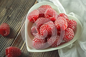 Red raspberries in white bowl