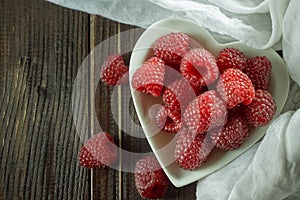 Red raspberries in white bowl