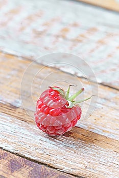 Red raspberry on old vintage wooden table.