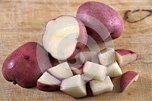 Red raw potatoes on flat surface