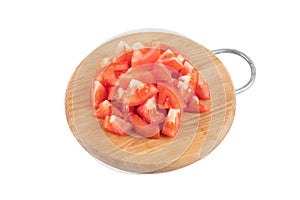 Red raw tomato slices diced on chopping board isolated in white background