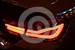 Red Rear light on a modern car with reflection. The Closeup Back Red Tail light car.