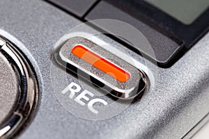 Red REC recording button on a modern pocket audio voice recorder, switch object macro extreme closeup Secretly recording photo