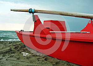 Red rescue boat with wooden oars