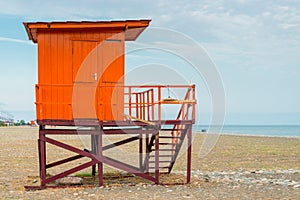 Red rescue tower on an empty beach
