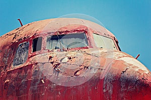 Red retired airplane. Cockpit of airplane wreck