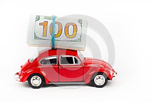 Red retro car with 100 dollar banknotes on white