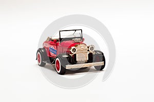 Red retro car, toy model on white background