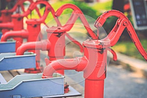 Red retro style hand water pump