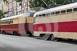 Red retro trams on a city road