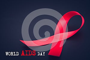 Red ribbon awareness on black background for World Aids day