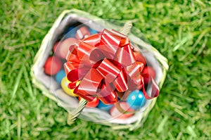 Red ribbon on basket of Easter eggs - Top view