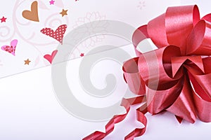 Red ribbon bow and hearts on white, valentines day concept