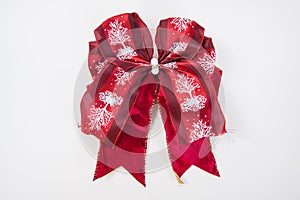 Red ribbon and bow isolated on white.