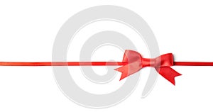 Red ribbon with bow on white. Festive decoration