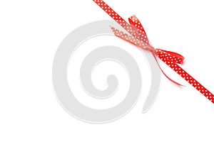 Red ribbon with bow on white. Festive decoration