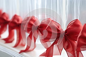 red ribbon bows on a frosted glass surface