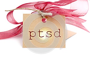 red ribbon and a brown paper with text on it