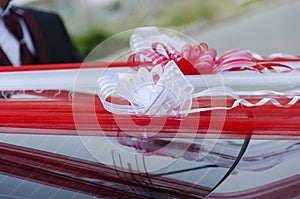 Red ribbon - decoration on wedding car