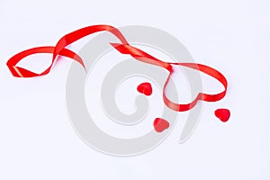 Red ribbon in the form of a heart and 3 hearts on a white background. Valentine`s day, declaration of love, birthday, mother`s day