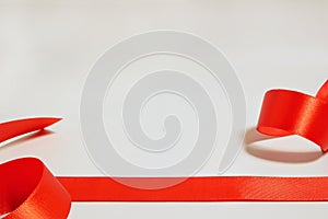 Red ribbon for gift wrapping on gray background
